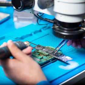 pexels-photo-12863114 Close-up of technician repairing electronic circuit board under a microscope in Toronto lab.