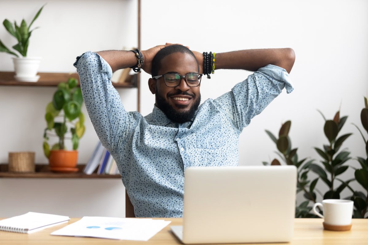 Smiling,Afro-american,Businessman,Holding,Hands,Behind,Head,Sitting,At,Office